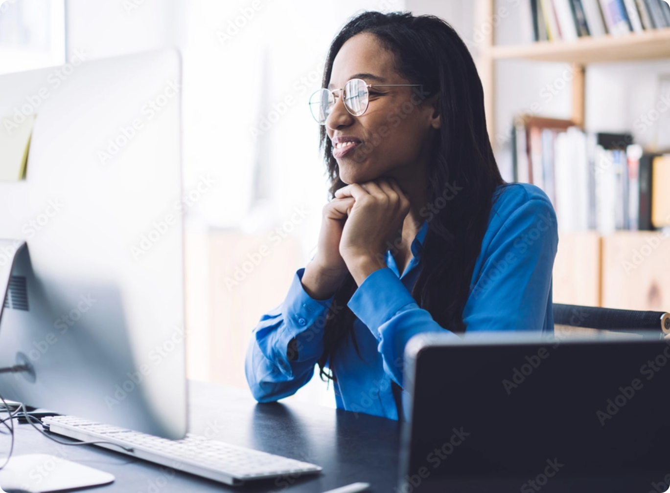 Smiling woman watching webinar on computer